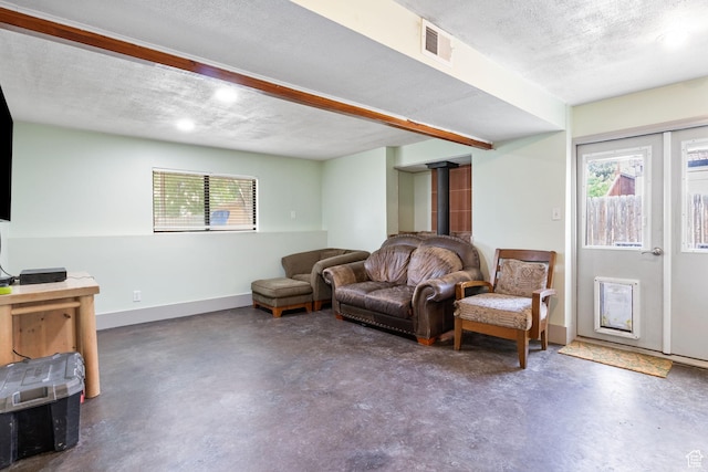 632 S 1150 W, Layton, UT 84041 - sitting room with finished concrete flooring, a wood stove, and a textured ceiling