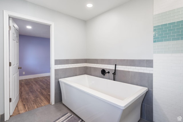 632 S 1150 W, Layton, UT 84041 - bathroom with tile walls, a freestanding bath, tile patterned flooring, recessed lighting, and a wainscoted wall