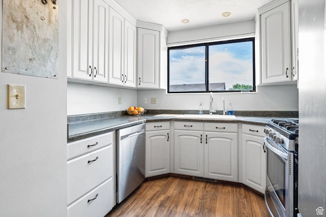 632 S 1150 W, Layton, UT 84041 - kitchen featuring stainless steel appliances, dark countertops, white cabinetry, and dark wood-type flooring