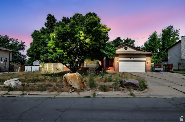 632 S 1150 W, Layton, UT 84041 - view of front of home with brick siding, concrete driveway, and a garage