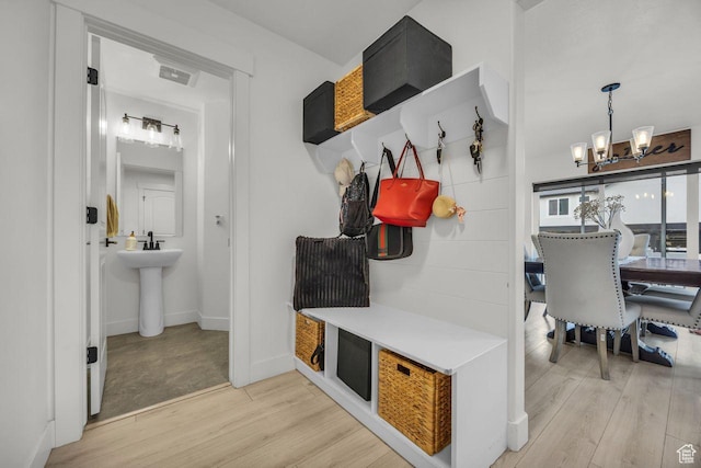 12357 S Eovaldi Ave, Herriman, UT 84096 - mudroom with a chandelier and light wood-style floors
