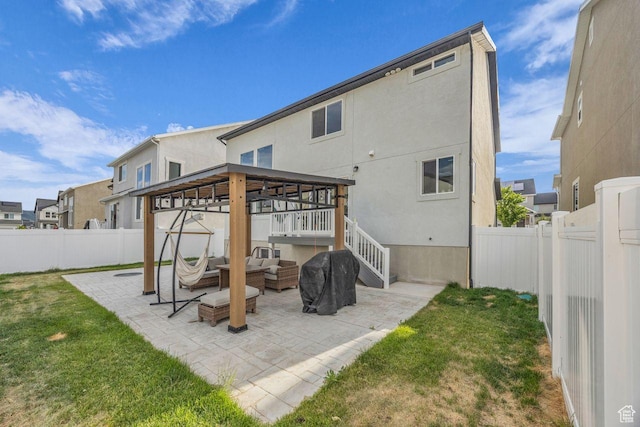 12357 S Eovaldi Ave, Herriman, UT 84096 - back of house with an outdoor living space, a fenced backyard, stucco siding, a patio, and a gazebo