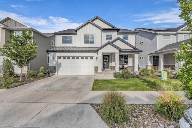 12357 S Eovaldi Ave, Herriman, UT 84096 - view of front facade with board and batten siding, a standing seam roof, driveway, an attached garage, and a metal roof