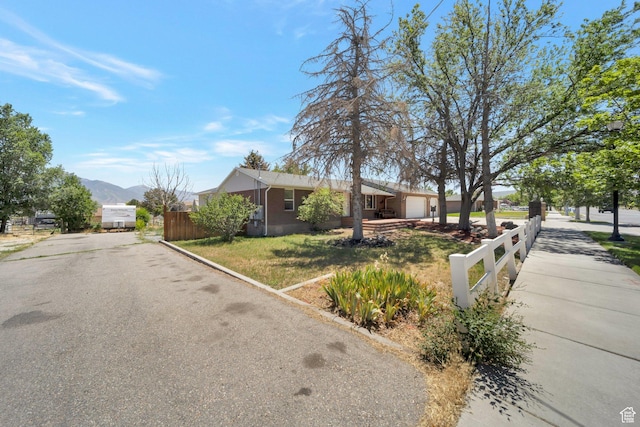 13155 S 3600 W, Riverton, UT 84065 - view of front of home with an attached garage, driveway, and a mountain view