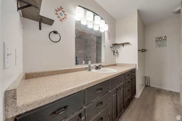 13155 S 3600 W, Riverton, UT 84065 - full bathroom featuring vanity, wood finished floors, and tiled shower