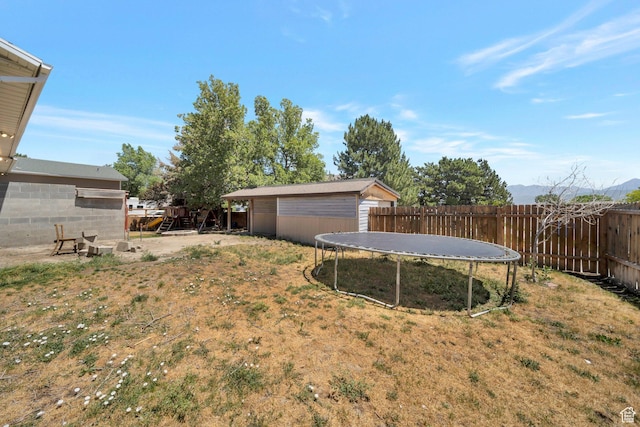 13155 S 3600 W, Riverton, UT 84065 - fenced backyard with a trampoline and an outbuilding