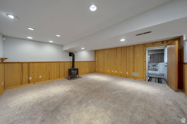 13155 S 3600 W, Riverton, UT 84065 - finished basement with a wood stove, wainscoting, carpet flooring, wood walls, and recessed lighting