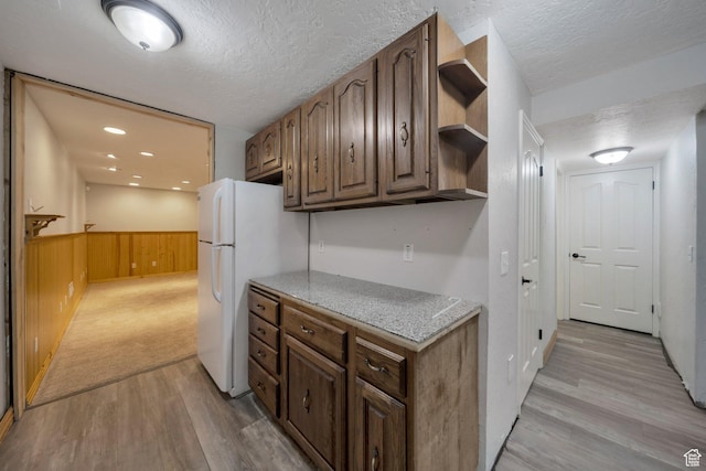 13155 S 3600 W, Riverton, UT 84065 - kitchen featuring open shelves, a textured ceiling, light wood finished floors, freestanding refrigerator, and a wainscoted wall