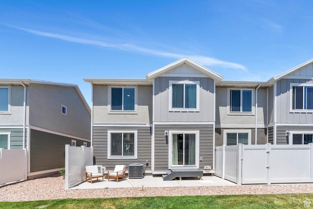 1127 W Hidden Spring Dr, Santaquin, UT 84655 - rear view of house with a gate, board and batten siding, a patio area, and an outdoor living space