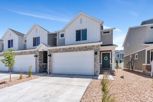 1127 W Hidden Spring Dr, Santaquin, UT 84655 - view of front of home with board and batten siding, a garage, driveway, and stone siding