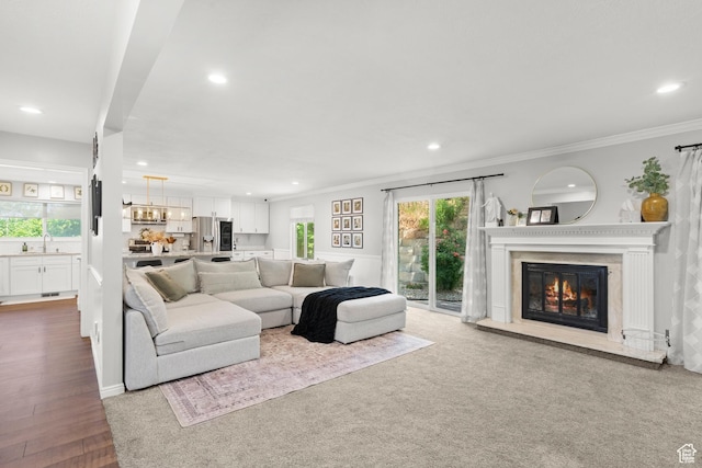 958 N Main St W, Farmington, UT 84025 - living room with recessed lighting, ornamental molding, a glass covered fireplace, a chandelier, and wood finished floors
