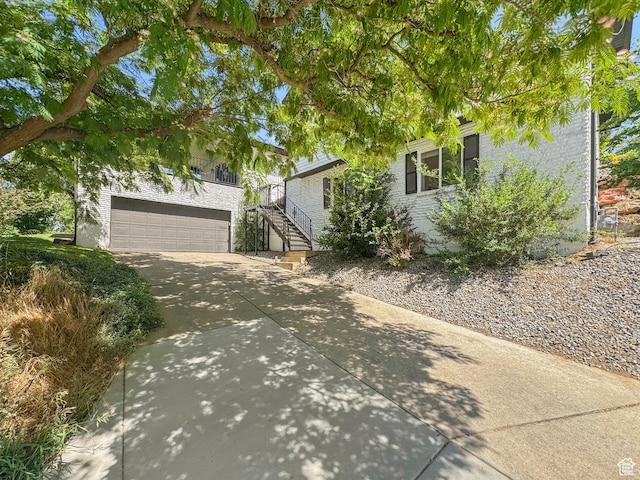 958 N Main St W, Farmington, UT 84025 - view of front of house featuring concrete driveway, stairs, and an attached garage