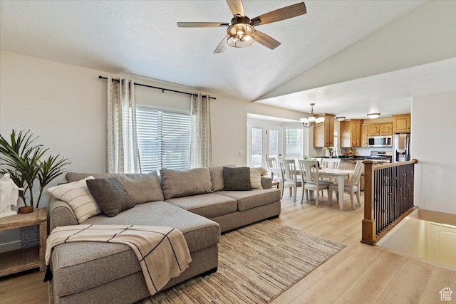 2876 S 1200 W, Syracuse, UT 84075 - living room with a chandelier, light wood finished floors, vaulted ceiling, a ceiling fan, and a textured ceiling