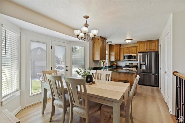 2876 S 1200 W, Syracuse, UT 84075 - dining space with a chandelier, light wood finished floors, and a textured ceiling