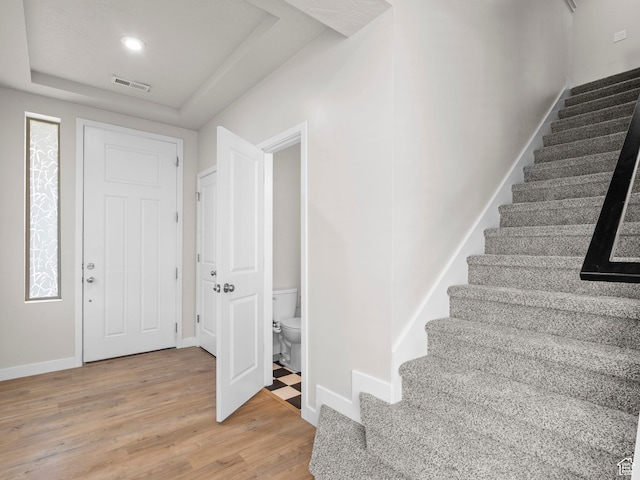 3199 W 2450 N, Lehi, UT 84043 - foyer featuring a tray ceiling, stairs, and light wood-style flooring