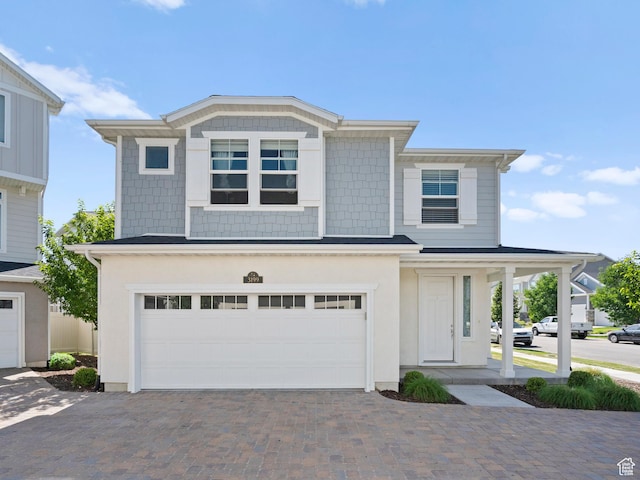 3199 W 2450 N, Lehi, UT 84043 - view of front of house with an attached garage, driveway, and stucco siding