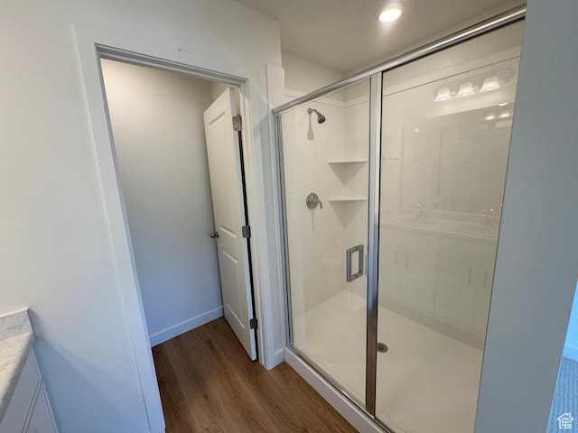 1650 N Main St N Unit 116, Layton, UT 84041 - bathroom featuring wood finished floors, a stall shower, and vanity