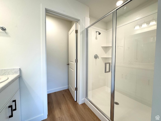 1650 N Main St N Unit 116, Layton, UT 84041 - bathroom with vanity, wood finished floors, and a stall shower