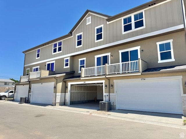 1650 N Main St N Unit 116, Layton, UT 84041 - view of front facade featuring a garage, board and batten siding, and a balcony