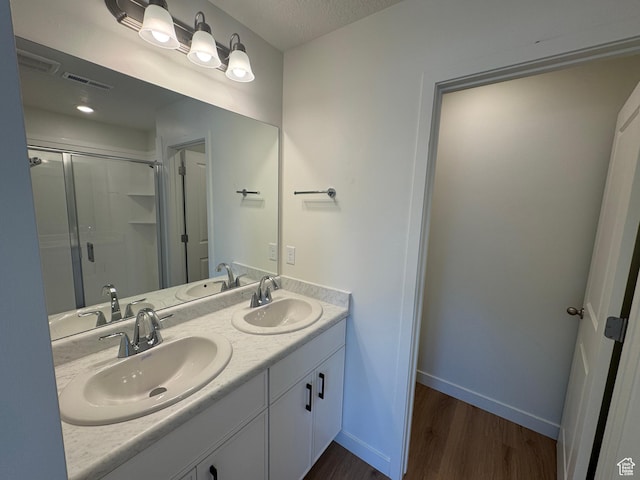 1650 N Main St N Unit 116, Layton, UT 84041 - full bathroom featuring wood finished floors, double vanity, and a stall shower