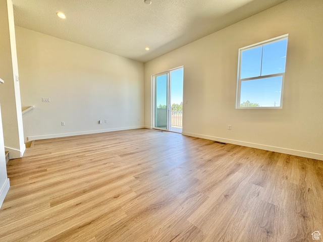 1650 N Main St N Unit 116, Layton, UT 84041 - unfurnished room with light wood finished floors, recessed lighting, and a textured ceiling