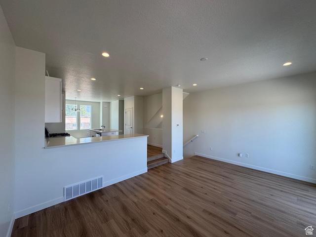1650 N Main St N Unit 116, Layton, UT 84041 - unfurnished living room featuring dark wood-style floors, recessed lighting, and a textured ceiling
