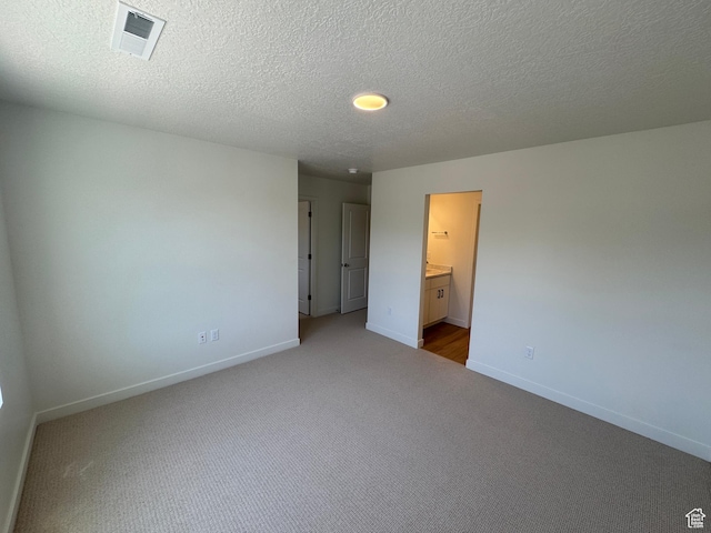 1650 N Main St N Unit 116, Layton, UT 84041 - unfurnished bedroom with carpet, a textured ceiling, and ensuite bath