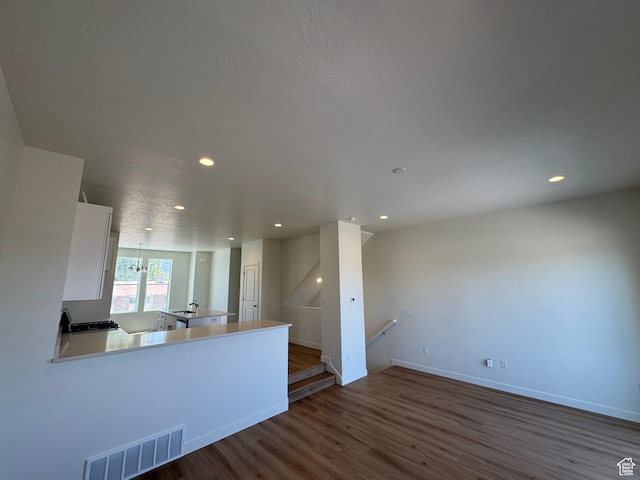 1650 N Main St N Unit 116, Layton, UT 84041 - unfurnished living room featuring dark wood-style flooring and recessed lighting