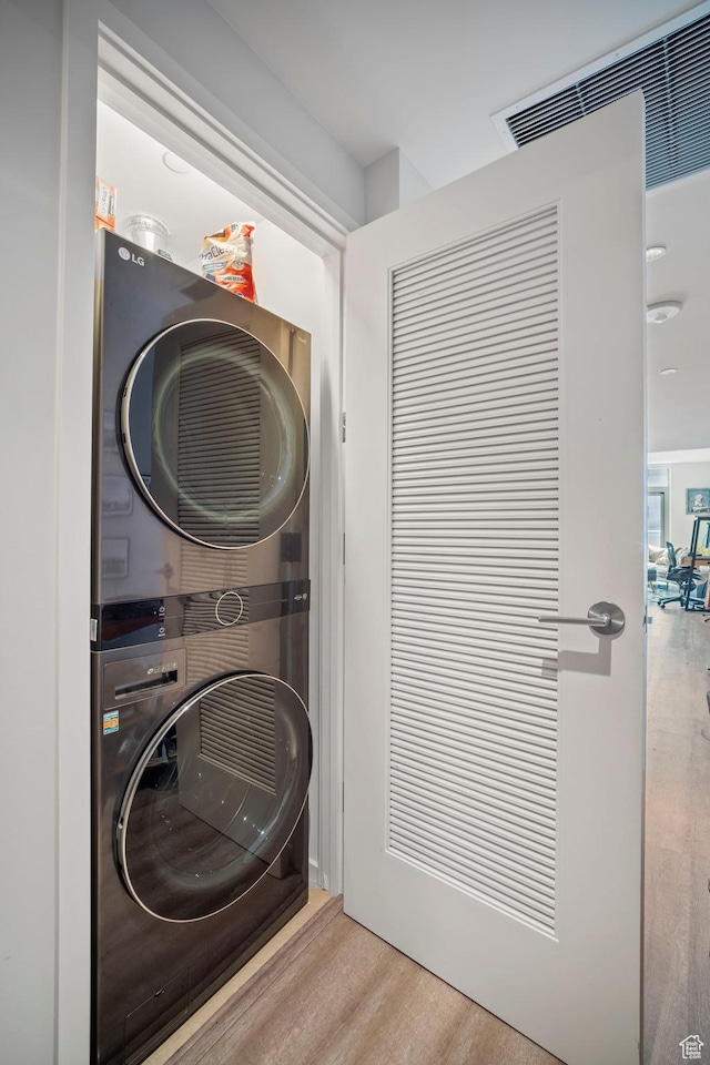 35 E 100 S Unit 708, Salt Lake City, UT 84111 - washroom with estacked washer and dryer and wood finished floors