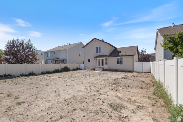 1919 E Church Way, Eagle Mountain, UT 84005 - back of house with a fenced backyard and entry steps