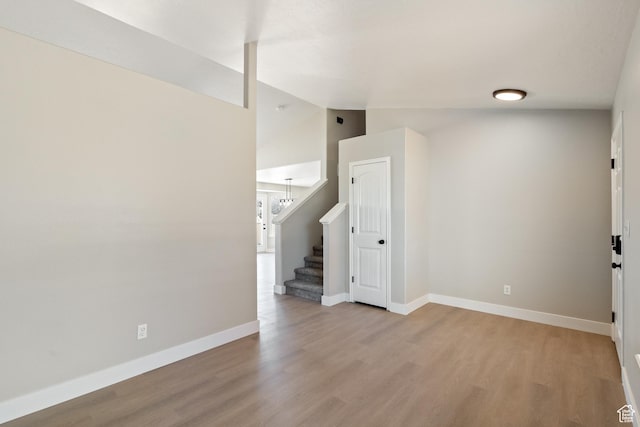 1919 E Church Way, Eagle Mountain, UT 84005 - empty room featuring light wood finished floors, stairs, and lofted ceiling