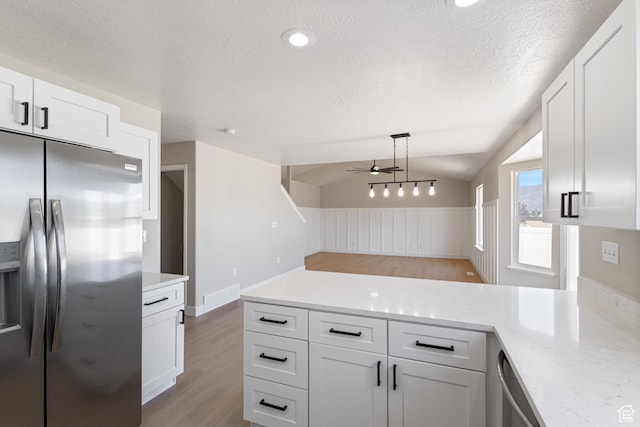 1919 E Church Way, Eagle Mountain, UT 84005 - kitchen featuring appliances with stainless steel finishes, a ceiling fan, light wood-style floors, a peninsula, and white cabinets
