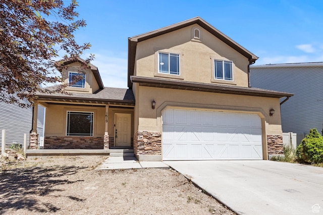 1919 E Church Way, Eagle Mountain, UT 84005 - view of front of house with stone siding, an attached garage, stucco siding, and driveway