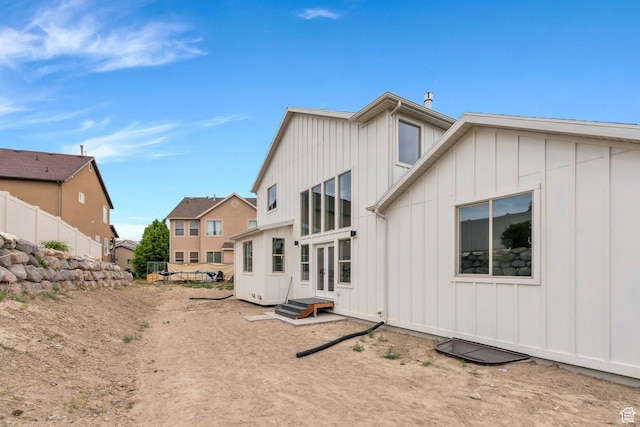 7625 N Silver Creek Way, Eagle Mountain, UT 84005 - rear view of property featuring board and batten siding and a residential view