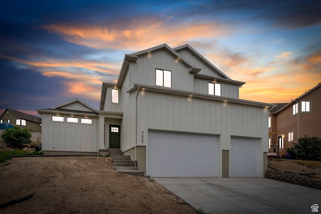 7625 N Silver Creek Way, Eagle Mountain, UT 84005 - view of front of property with an attached garage, driveway, and board and batten siding