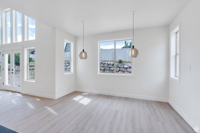 7625 N Silver Creek Way, Eagle Mountain, UT 84005 - unfurnished dining area featuring healthy amount of natural light and light wood-style flooring