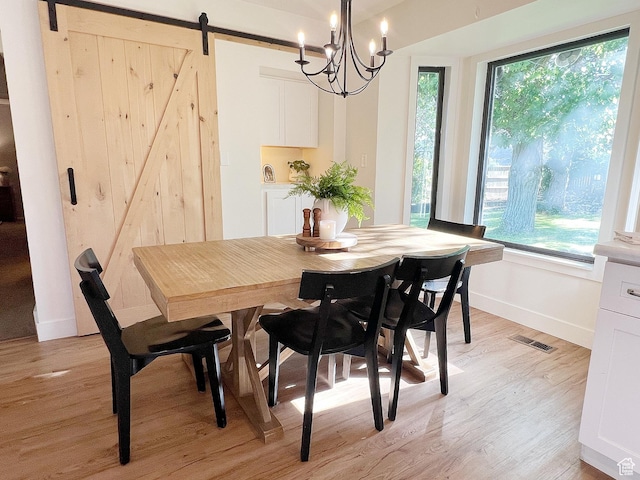 920 S 940 W, Richfield, UT 84701 - dining space with a barn door, plenty of natural light, light wood-style floors, and a chandelier