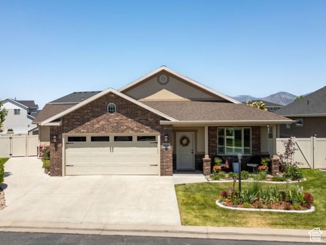 1065 W 2740 S, Nibley, UT 84321 - view of front of house with a garage, a gate, concrete driveway, and brick siding