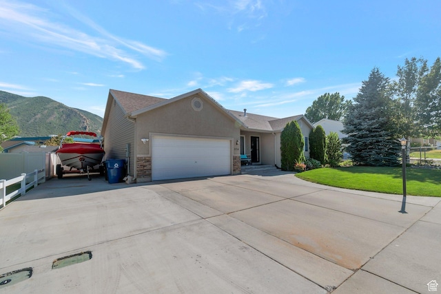 2714 E Stony Hill Way S, Spanish Fork, UT 84660 - ranch-style home featuring a garage, driveway, a mountain view, stone siding, and stucco siding