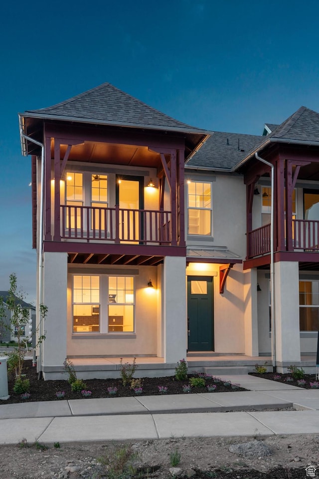 6658 W Docksider Dr, South Jordan, UT 84009 - view of front facade featuring a balcony, stucco siding, and a shingled roof