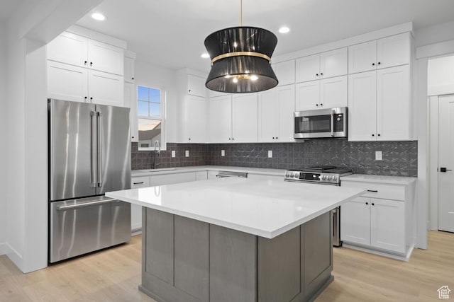 6658 W Docksider Dr, South Jordan, UT 84009 - kitchen featuring appliances with stainless steel finishes, light countertops, light wood-type flooring, white cabinets, and recessed lighting