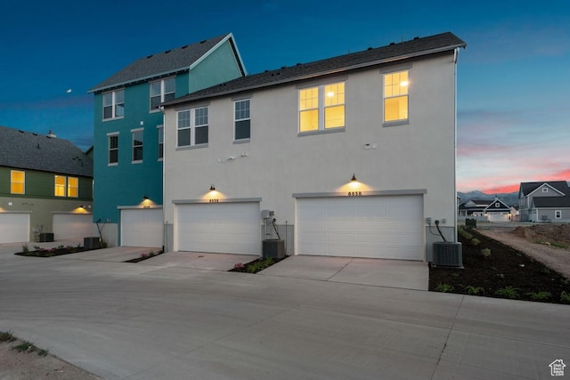6658 W Docksider Dr, South Jordan, UT 84009 - rear view of property with stucco siding, a garage, and concrete driveway