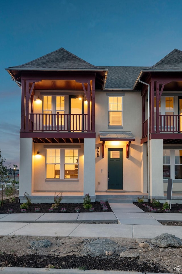 6658 W Docksider Dr, South Jordan, UT 84009 - view of front facade featuring stucco siding, a shingled roof, and a balcony
