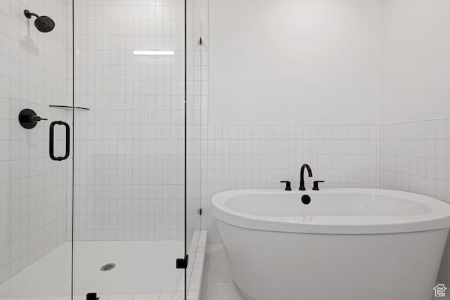 6658 W Docksider Dr, South Jordan, UT 84009 - full bathroom featuring a stall shower, a soaking tub, and tile walls