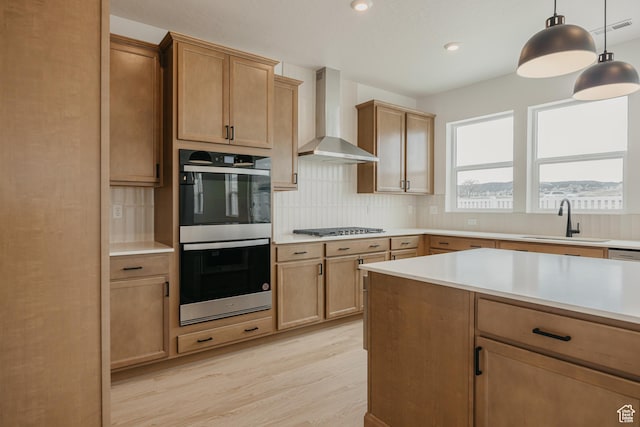 189 N Woodrun Way Unit 131, Saratoga Springs, UT 84045 - kitchen featuring appliances with stainless steel finishes, wall chimney exhaust hood, light wood finished floors, decorative backsplash, and light countertops
