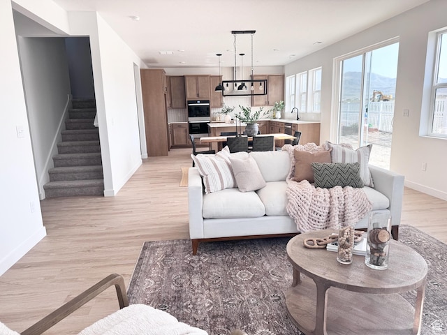 189 N Woodrun Way Unit 131, Saratoga Springs, UT 84045 - living area with stairway, light wood-style floors, and a mountain view