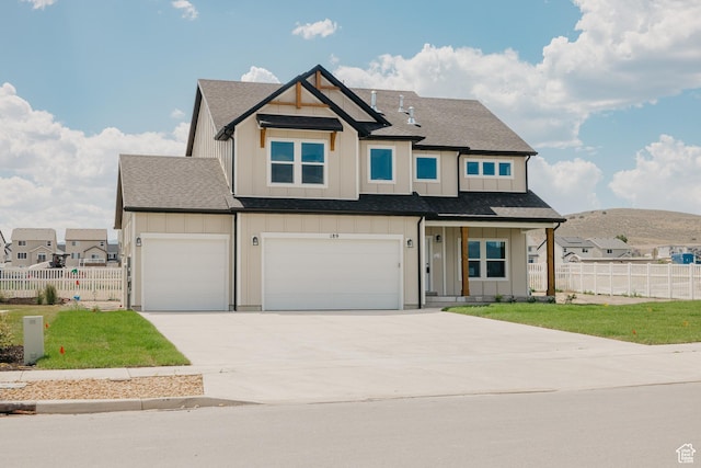 189 N Woodrun Way Unit 131, Saratoga Springs, UT 84045 - view of front facade featuring board and batten siding, concrete driveway, a garage, and a mountain view