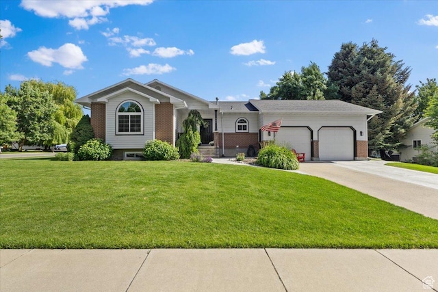 980 E 2850 N, North Logan, UT 84341 - view of front of home featuring an attached garage, brick siding, a front yard, and driveway