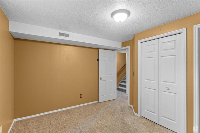 980 E 2850 N, North Logan, UT 84341 - unfurnished bedroom featuring light colored carpet, a textured ceiling, and a closet