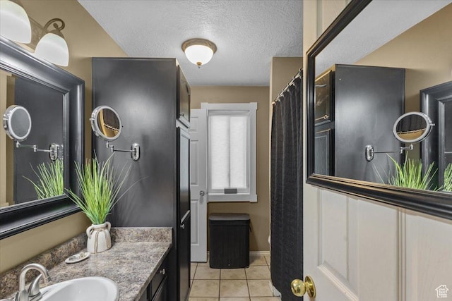 980 E 2850 N, North Logan, UT 84341 - full bathroom featuring tile patterned flooring, a textured ceiling, and vanity